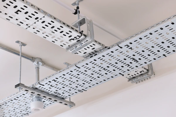 Perforated cable tray installed above a ceiling